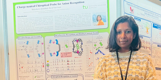 Malavika in front of her poster at the ISMSC 2023 conference.